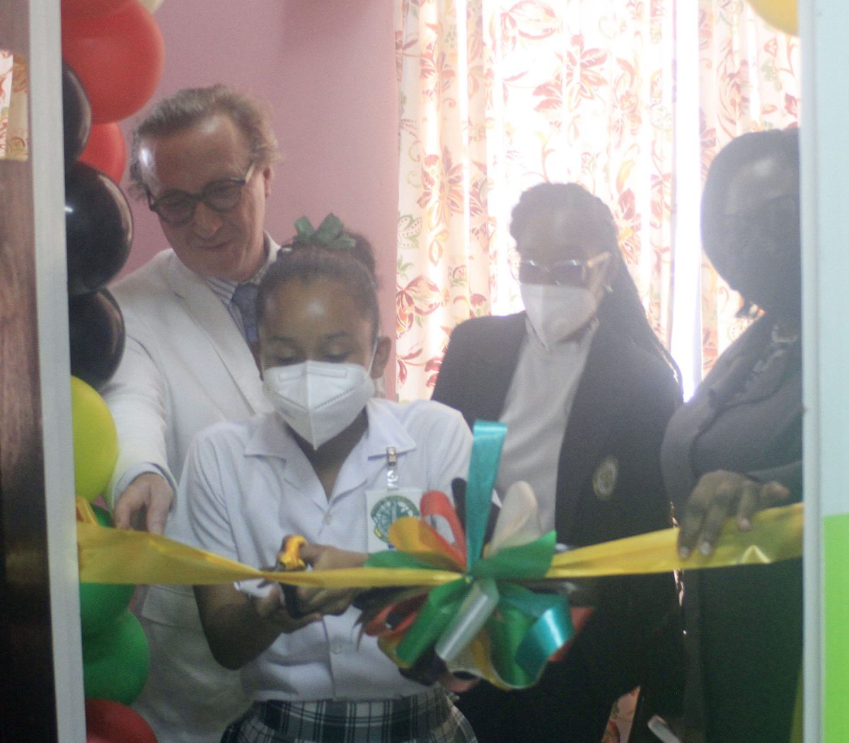 A student cutting the ribbon to declare the new Juvenile Drug Treatment Court open. The court is housed at the Georgetown Magistrate’s Court complex. 