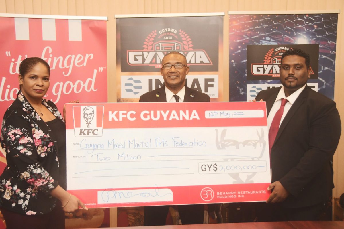 BRH Marketing Manager Pamela Manasseh (left) handing over the cheque to GMMAF Vice-President Sherwin Sandy in the presence of Charles Greaves 
