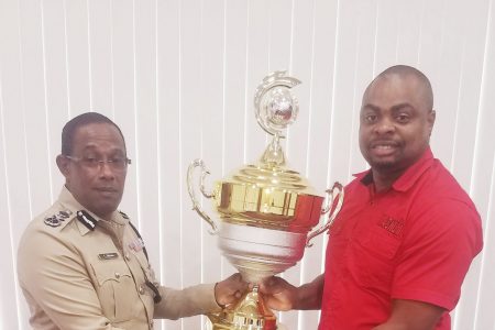 Commissioner of Police Clifton Hicken (Ag.) (left) hands over
‘The Commissioner of Police Championship Trophy’ to organizer Edison Jefford for the Magnum Independence Football Cup.