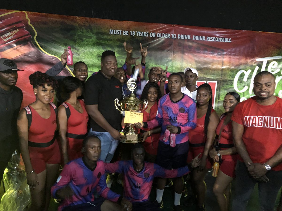 Captain of Back Circle Stephon McLean receiving the championship from Magnum Brand Manager Jamal Baird while teammates, tournament officials, and brand representatives look on