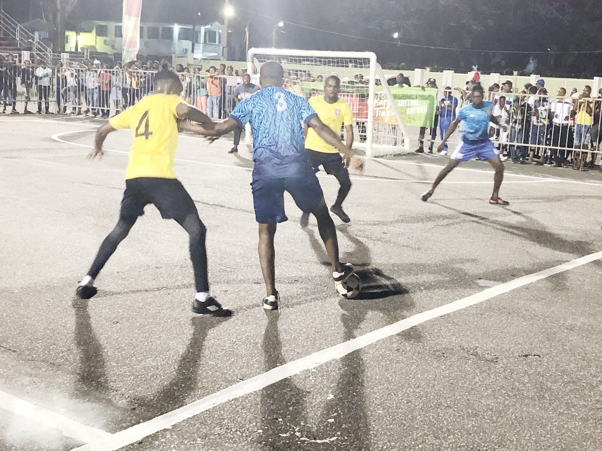 Carl Tudor (blue) of North East La Penitence trying to shield the ball away from a BV player during their clash in the Magnum Independence Cup