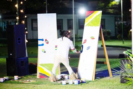 Self-taught speed painter Winston Alexander working on a piece at Saturday night’s State Dinner held by President Irfaan Ali and First Lady Arya Ali in honour of the visiting Heads of Government of CARICOM. (Office of the President photo)
