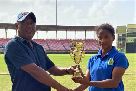 Player of the match, Kaysia Schultz who scored 63 and picked up 3-12 collects her award from national selector, Elroy Stephney