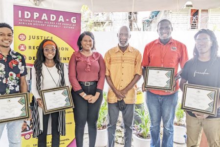 IDPADA-G's Youth Committee Chair, Ascena Jacobs (third from left) and Chairman of IDPADA-G, Vincent Alexander (third from right) pose with the winners of the organisation's Invest-A-Thon/Pitch Competition.