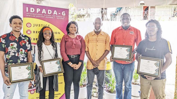 IDPADA-G's Youth Committee Chair, Ascena Jacobs (third from left) and Chairman of IDPADA-G, Vincent Alexander (third from right) pose with the winners of the organisation's Invest-A-Thon/Pitch Competition.