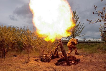 A Ukrainian serviceman fires with a mortar at a position at a location in Kharkiv region, Ukraine May 9, 2022. (Reuters)