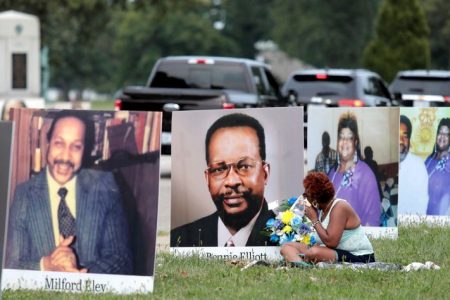 FILE PHOTO: Pictures of Metro Detroit residents, who died from the coronavirus disease (COVID-19), line the street during a drive through memorial, on Belle Isle in Detroit, Michigan, U.S. September 1, 2020. REUTERS/Rebecca Cook/File Photo