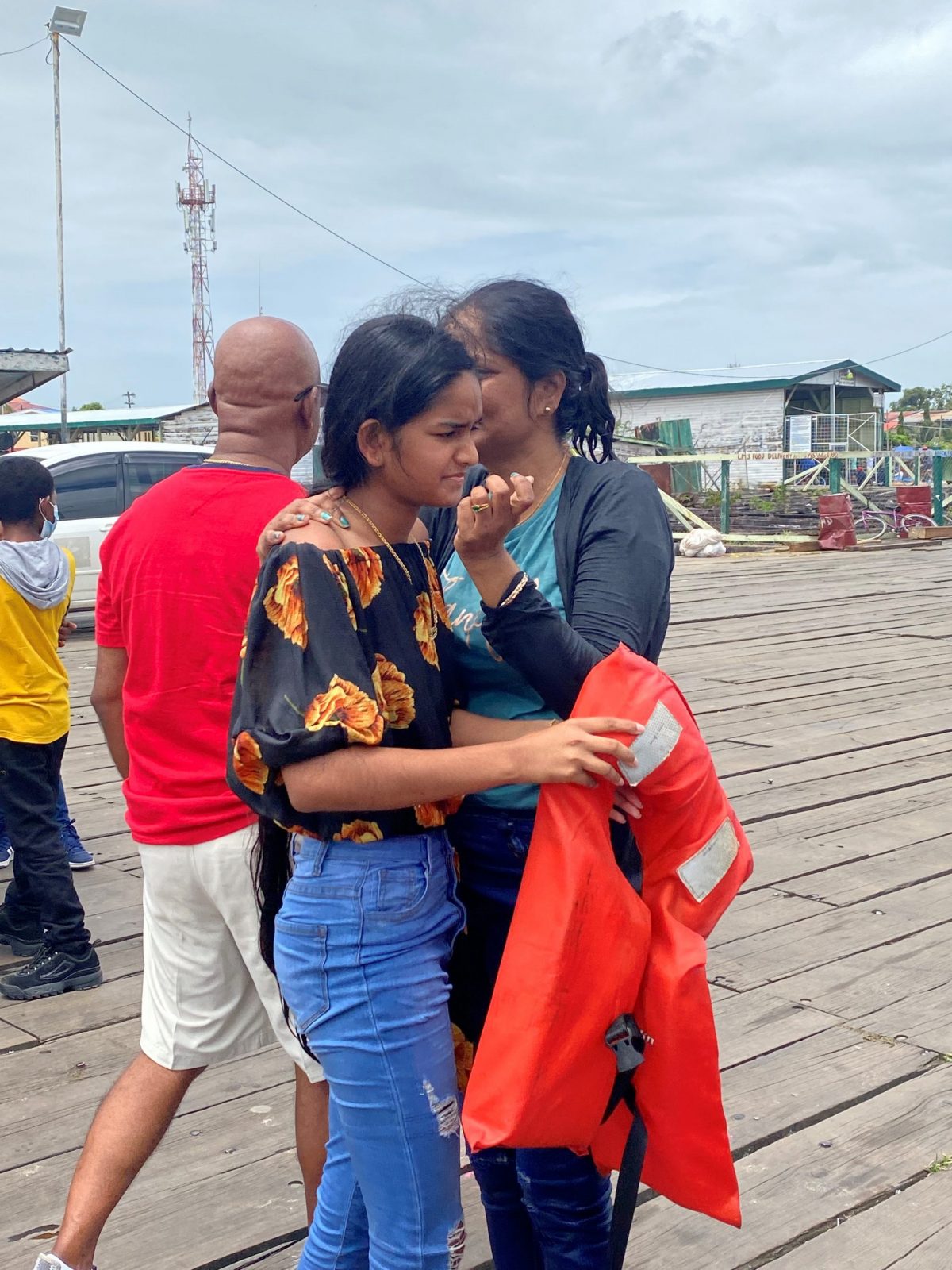 Diya Seenauth (foreground) comforting her aunt