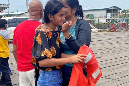 Diya Seenauth (foreground) comforting her aunt