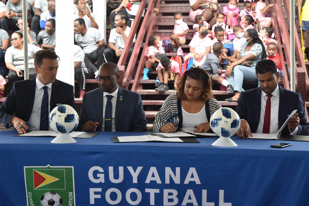 Inked! From left Project Leader Alexandre Gros of FIFA, GFF President Wayne Forde, Minister of Education Priya Manickchand, and Minister of Culture, Youth and Sport, Charles Ramson Jr., signing the Memorandum of Understanding to solidify the Football for Schools Project.