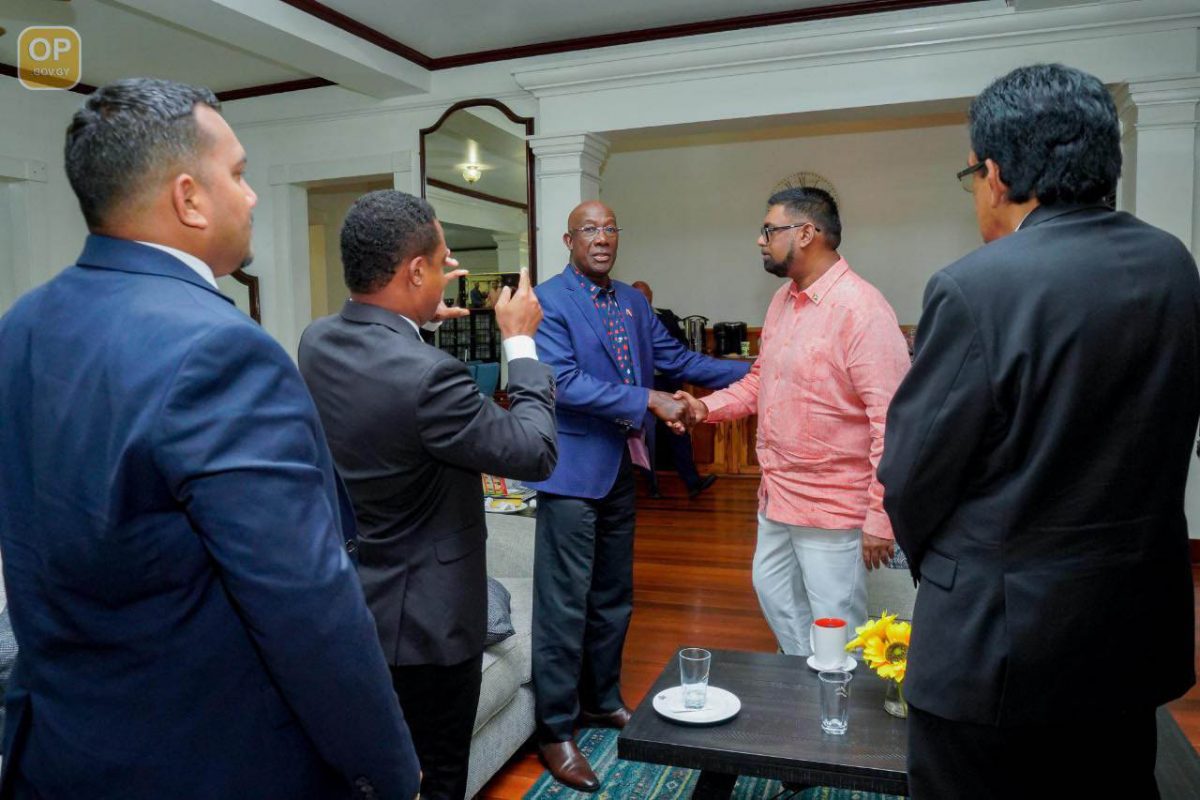 President Irfaan Ali (second from right) shaking hands with Trinidad’s Prime Minister Keith Rowley at State House on Sunday (Office of the President photo)