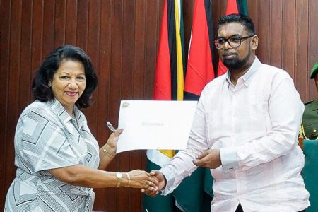 Chandra Gajraj (left) receiving her instrument of appointment from President Irfaan Ali (Office of the President photo)