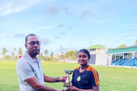 Ashmini Munisar collects her player-of-the-match award from Andre Percival