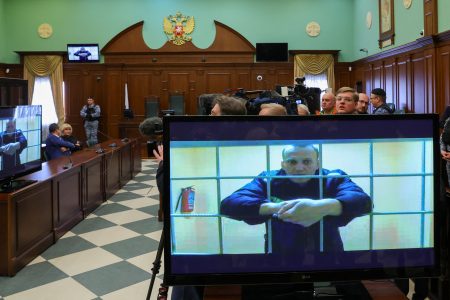 Russian opposition leader Alexei Navalny is seen on screens via a video link from the IK-2 corrective penal colony in Pokrov during a court hearing to consider an appeal against his prison sentence in Moscow, Russia May 24, 2022. REUTERS/Evgenia Novozhenina