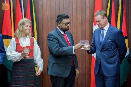 Norway’s new envoy to Guyana,  Odd Magne Ruud (right) sharing a toast with President Irfaan Ali. (Office of the President photo)