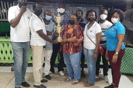 Yonette Christmas of Phantom/Next Level receives the first place trophy from GDA Vice President, Colin Boyce, while elated team members and members of the GDA Fundraising Committee look on.