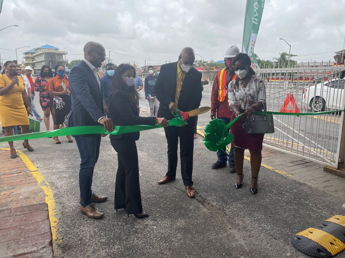 Minister of Public Works Juan Edghill (third from left) cuts the ceremonial ribbon as GTT VP of Business Solutions Orson Ferguson (left) and MMG’s General Manager Bobita Ram (second from left) and others look on.