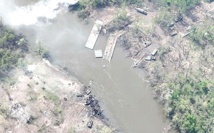 A damaged crossing with destroyed Russian armoured vehicles is seen on the Siverskyi Donets River on Thursday. (AP pic)