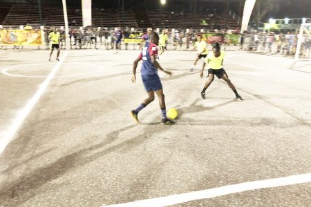 Randy Roberts (no.9) of Road Warriors on the attack from the left flank against Albouystown in the Magnum Independence Cup Saturday night.
