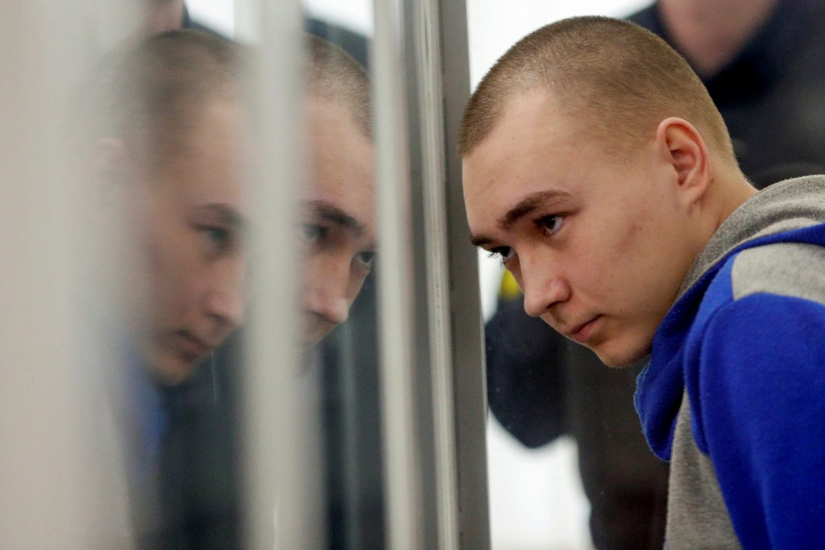 Russian soldier Vadim Shishimarin, 21, suspected of violations of the laws and norms of war, sits inside a cage during a court hearing, amid Russia's invasion of Ukraine, in Kyiv, Ukraine May 23, 2022. REUTERS/Viacheslav Ratynskyi