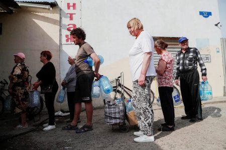 Local residents queue to collect water in the course of Ukraine-Russia conflict in the town of Rubizhne in the Luhansk region, Ukraine June 1, 2022. REUTERS/ Alexander Ermochenko