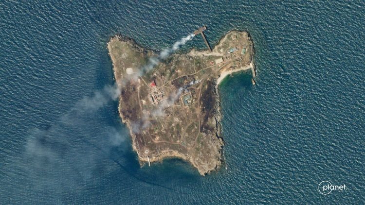 A satellite image shows smoke rising from Snake Island, off the coast of Ukraine, June 29, 2022. Planet Labs PBC/Handout via REUTERS 