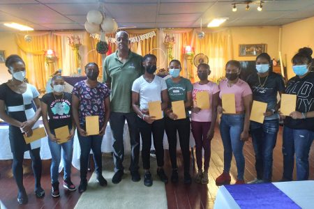The nine players pose with Courtney Walsh after receiving their stipends
