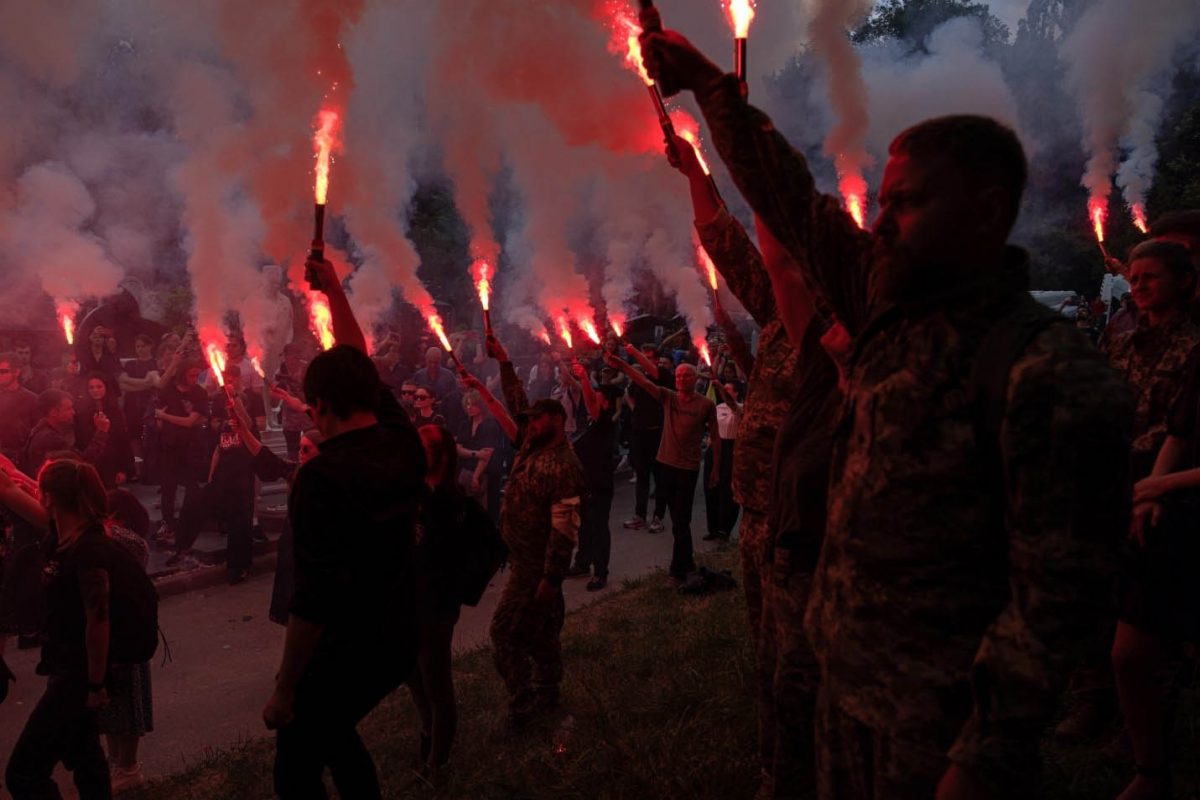 Friends and comrades light up flares during the funeral ceremony for Ukrainian serviceman and activist Roman Ratushnyi, who was killed in fighting in the Kharkiv region, at a cemetery in Kyiv, Ukraine, 18 June 2022. Ratushnyi, a prominent Ukrainian political activist, who served as a reconnaissance officer in Ukraine's 93rd Independent Kholodnyi Yar Mechanized Brigade, was killed in fighting near Izium, Kharkiv region on 09 June amid Russia's invasion. EPA-EFE/ROMAN PILIPEY 