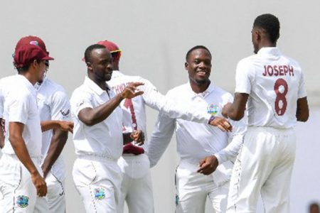 Fast bowler Alzarri Joseph (right) is congratulated by teammates after taking another wicket on Thursday. (Photo courtesy CWI Media) 