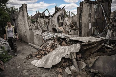 A man walks next to his destroyed house in the city of Lysychansk, in the eastern Ukrainian region of Donbas. Photo: AFP