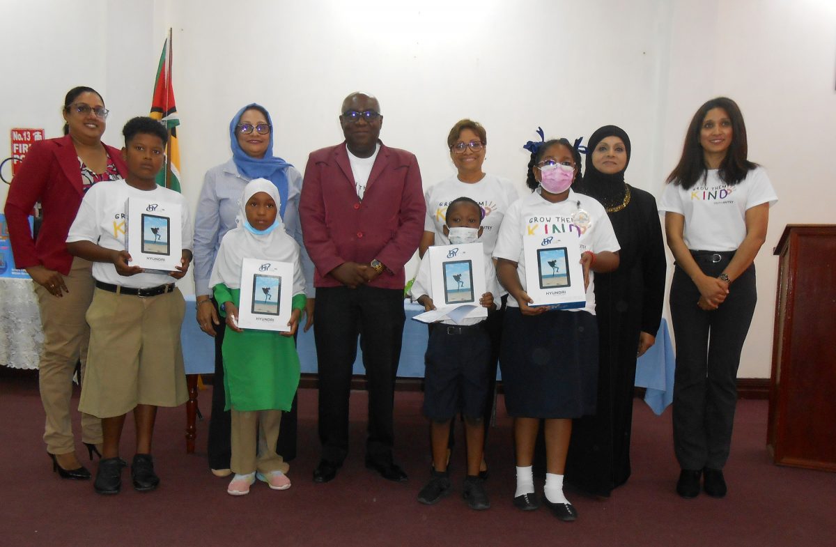 Chief Education Officer, Dr. Marcel Hutson (centre),  Janice Hall (third from right in back row) , Founder of We Are GUTSY and Rosalinda Rasul (right) , Head of the Diaspora Unit with students, teachers and members of the GUTSY programme. (Ministry of Foreign Affairs photo) 