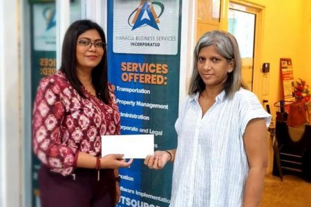 Managing Director of Pinnacle Business Services Inc., Samantha Lucknauth presents a cheque to Marcia Lee of the Guyana Chess Federation.