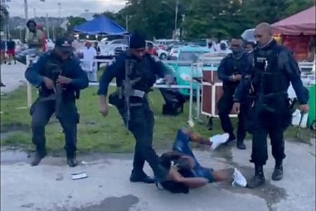 A screen grab of the police officers who were recorded trying to subdue two men at a fete at Queen’s Park Savannah yesterday.