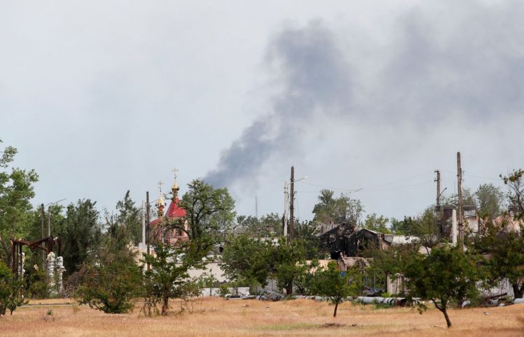 Smoke rises above a church and residential buildings in the course of Ukraine-Russia conflict in the town of Rubizhne in the Luhansk region, Ukraine June 1, 2022. REUTERS/Alexander Ermochenko