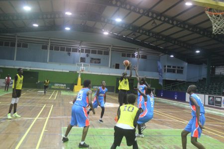 Francois Myers of Queen’s College attempts a jump shot against the D-UP Academy of Tuschen in the National School Basketball Festival (NSBF) Boy’s Pre-Season at the Cliff Anderson Sports Hall, Homestretch Avenue Sunday.