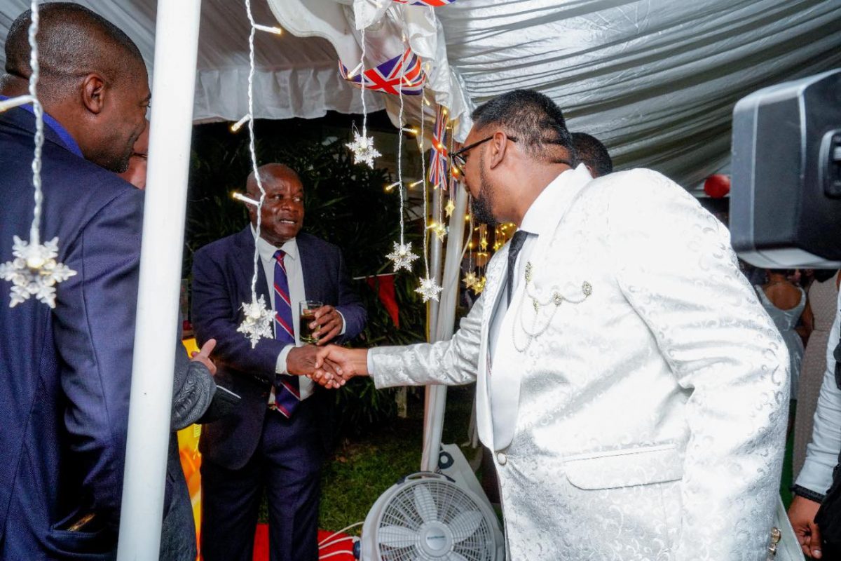 President Irfaan Ali (right) and Opposition Leader Aubrey Norton shaking hands at last night’s birthday reception for Queen Elizabeth held at the residence of the British High Commissioner to Guyana, Jane Miller. (Office of the President photo) 