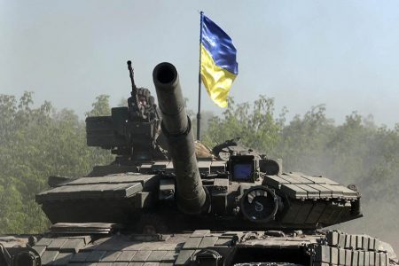 An Ukrainian soldier rides a tank on a road in the eastern Ukrainian region of Donbas on June 21, 2022.