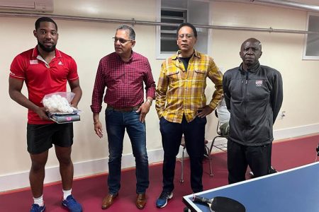  From left, National table tennis player Shemar Britton displays the equipment he received from overseas-based Guyanese Souvenir Ramdehol, second left, Andrew Gorsira and Sydney Christophe. (Absent is Mike Christophe).
