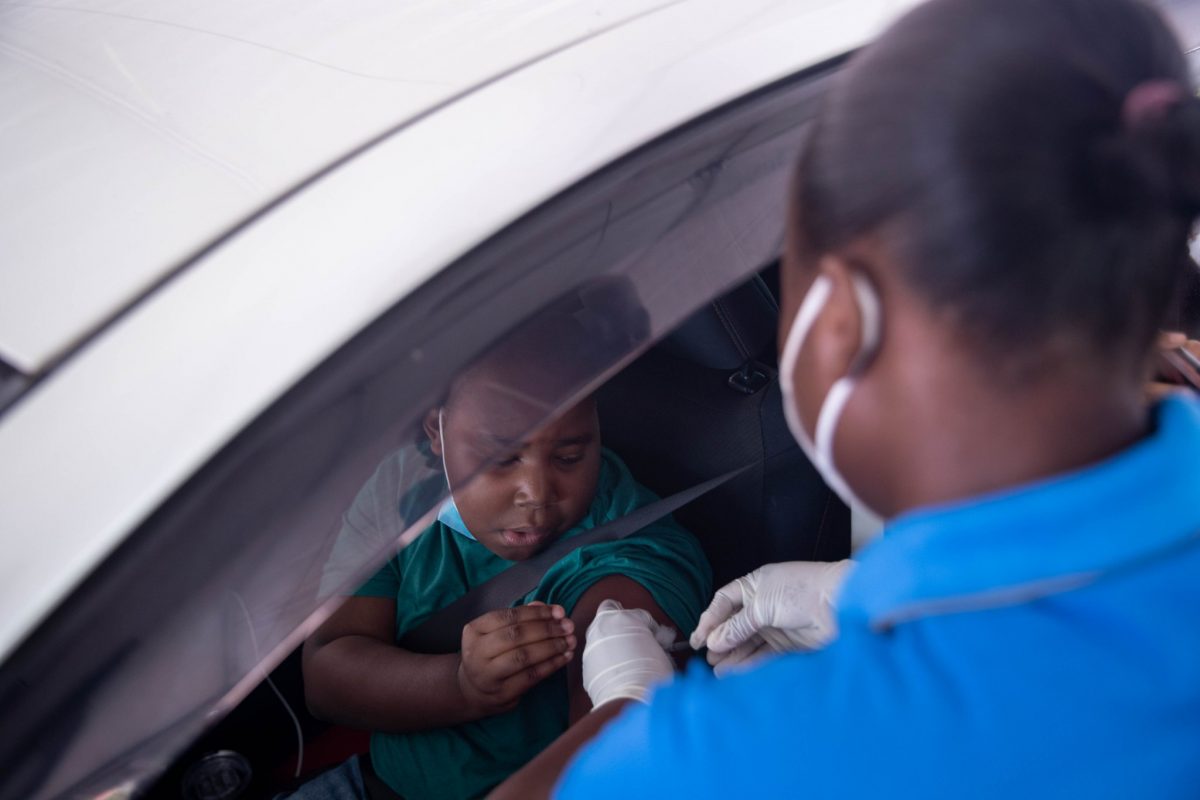 One of the country’s first recipients of the COVID-19 vaccine for children ages 5 to 11. The national vaccination programme for the age cohort was launched via a ‘Drive Thru’ exercise yesterday at the National Cultural Centre tarmac. (Department of Public Information photo) 