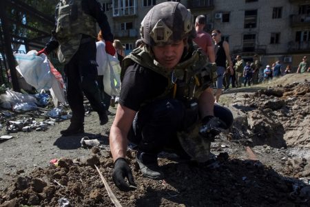 A police expert works near an apartment building destroyed in a military strike, amid Russia’s invasion of Ukraine, in Kurakhove, Ukraine June 7, 2022. REUTERS/Anna Kudriavtseva