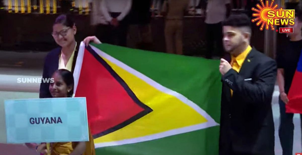 Guyana is among 187 teams participating in the 2022 Chess Olympiad in Chennai, India. In this screenshot from Tamil TV station Sun News, 2022 Women’s Champion Pooja Lam (left) and player Roberto Neto bear the Guyana flag.  