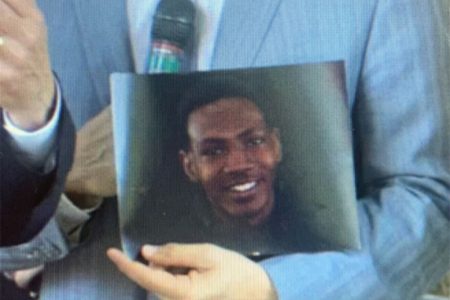 Attorney Bobby DiCello holds a photograph of 25-year-old Jayland Walker at a press conference Thursday afternoon.