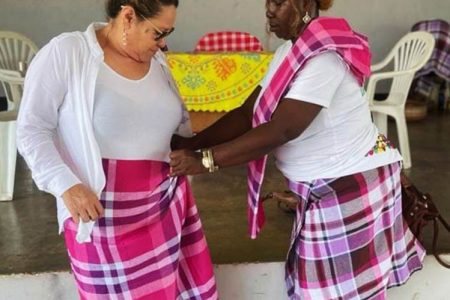 Jude Da Silva being clothed with a symbol of a matured woman by a member of the Samaaka people in Brownsburg, Suriname recently