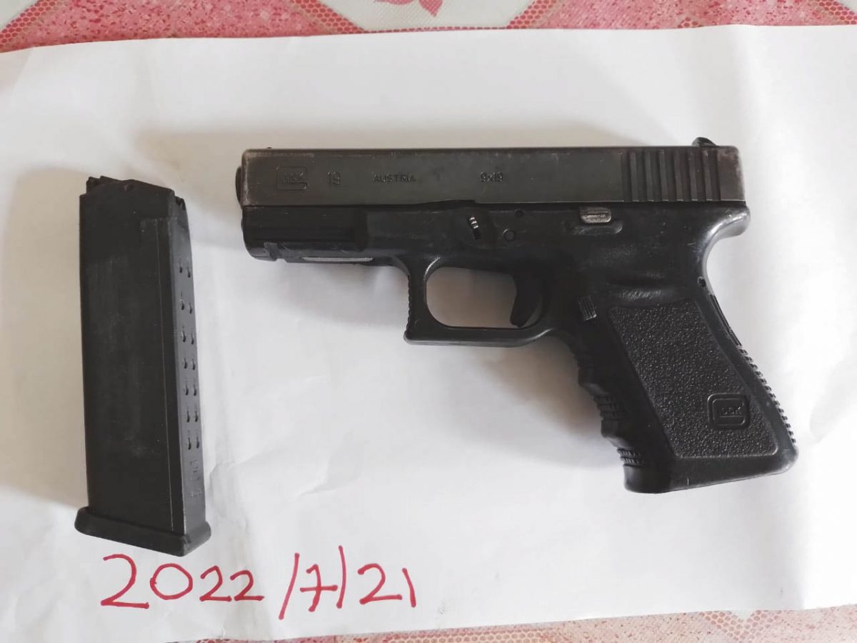 The pistol and empty magazine that were found by police  (Guyana Police Force photo) 
