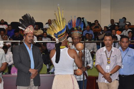 Toshao Nicholas Fredericks of Shulinab (third from right) being presented with symbolic tokens by the outgoing Chairman of the National Toshaos Council Joel Fredericks (back to camera) at his election in 2018 at the Arthur Chung Conference Centre, Liliendaal. (Stabroek News file photo)