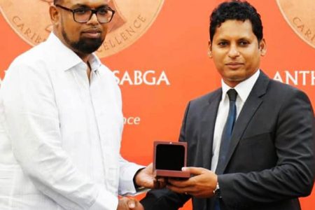 President Irfaan Ali presents the Anthony N Sabga Caribbean Award for Excellence in the category of entrepreneurship to Shyam Nokta (Office of the President photo) 