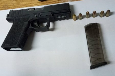 The unlicensed 9mm Glock pistol and ammunition that were allegedly found in the suspect’s possession. (Police photo)