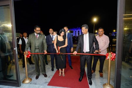 President Irfaan Ali (left) along with Robert Badal (right) and his wife Priya Badal cutting the ceremonial ribbon 
