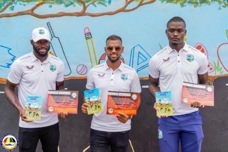 The West Indies trio (from left) Anderson Phillip, Nicholas Pooran, and Jayden Seales displaying their signed copies of the ICAN pledge against domestic violence