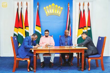 Signing on: Guyana foreign Affairs Minister Hugh Todd and his Trinidad and Tobago counterpart Amery Browne sign the MOU in the presence of President Ali and Prime Minister Rowley (SN file photo)